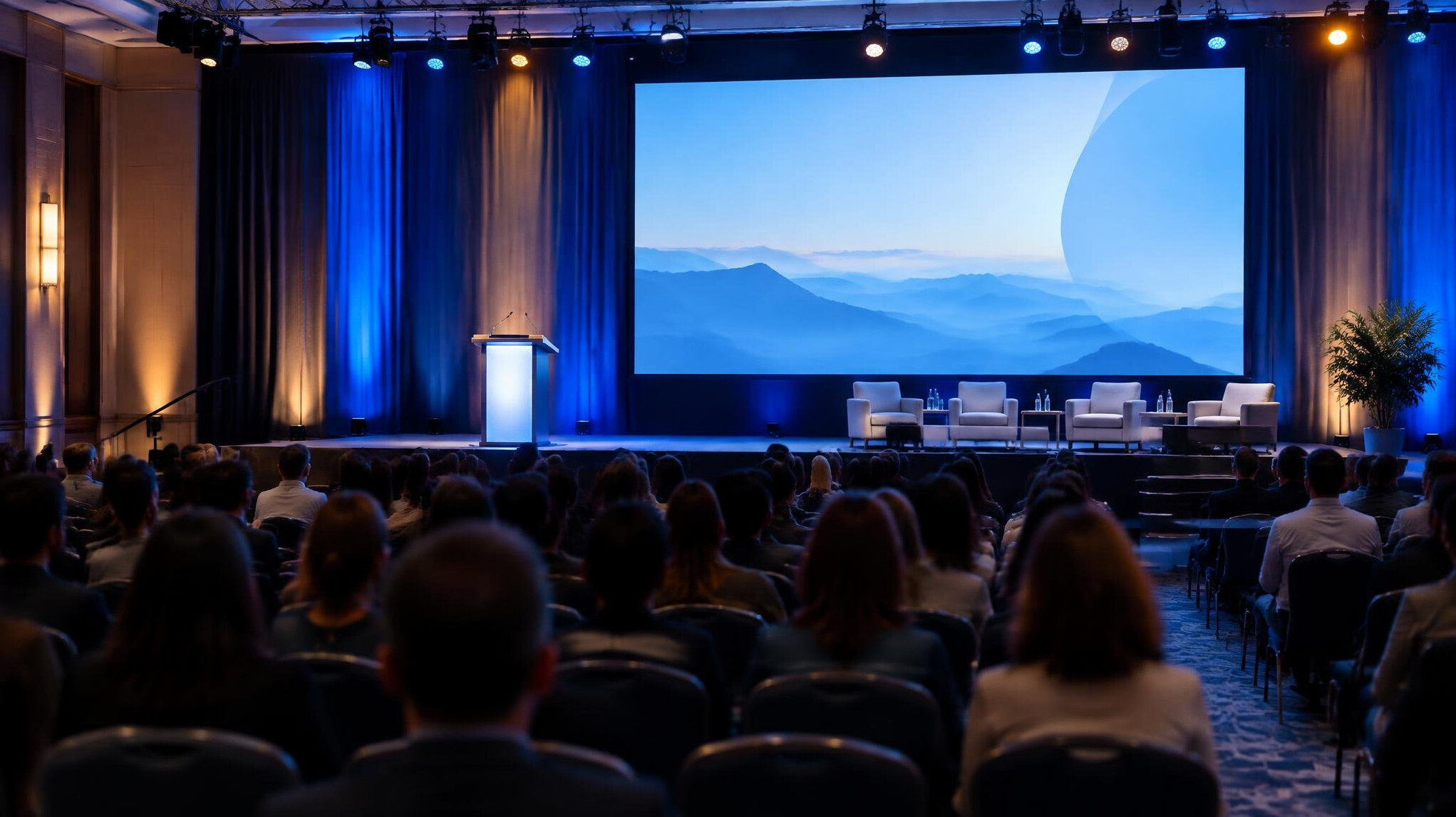 Conference stage with lit podium and audience