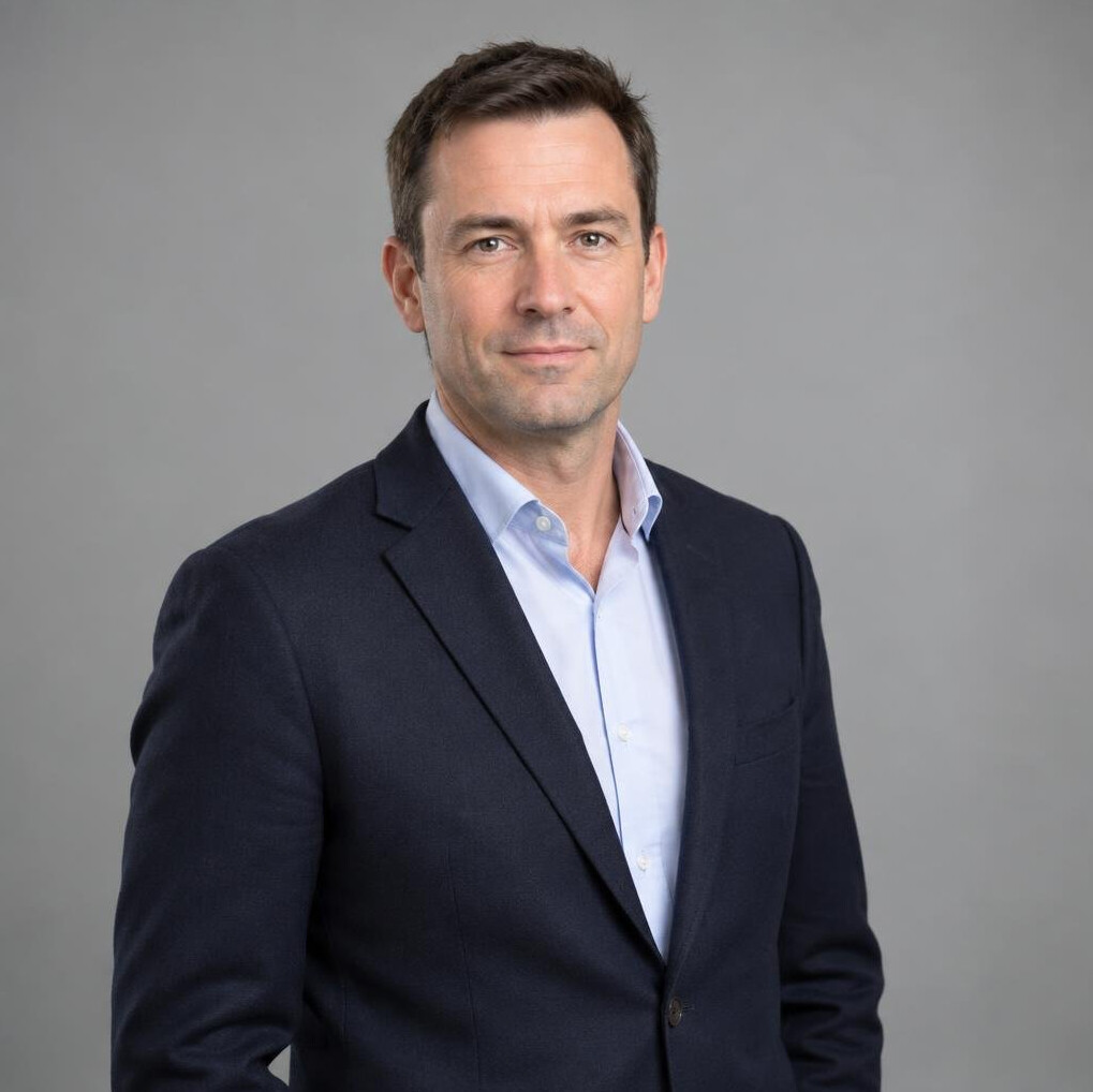 Professional portrait of a man in a dark blazer